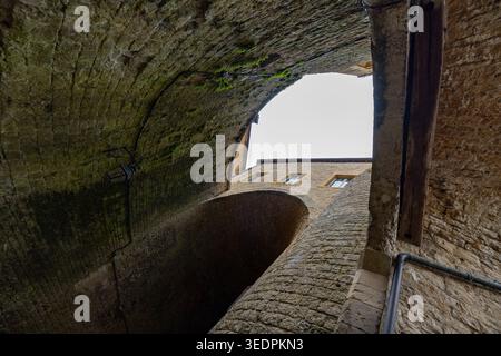 Castle of Sedan, Sedan, Rethel, Ardennes, Grand-Est, France, August, 28th, 2025, Stone vault opening to blue sky and aged bricks, Cinematic shot of brick arch revealing clear sky and ancient masonry Stock Photo