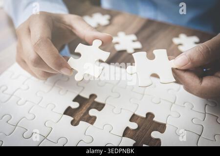 Completing  jigsaw puzzles with the last piece. Business success strategic solutions and problem solving challenge concept. Stock Photo
