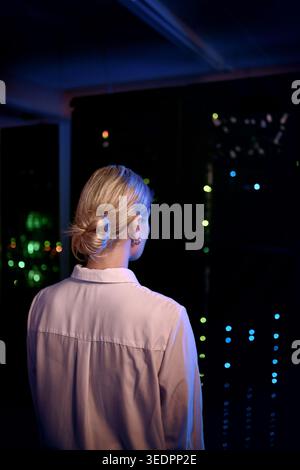Back, woman and programmer with mainframe in server room for inspection, cybersecurity and repairs. Employee, technician and data center for Stock Photo
