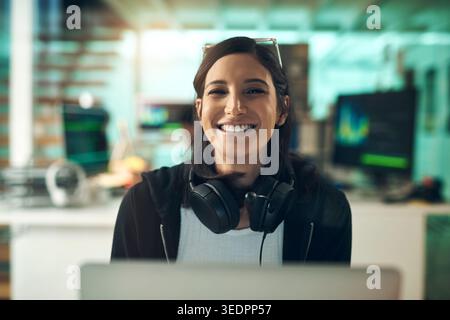 Happy woman, headphones and portrait with software engineer in office for cybersecurity service. Female person, programmer or hacker with smile for Stock Photo