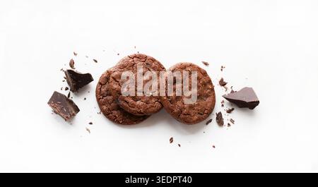 Dark chocolate chip cookies with crumbs isolated on white background. Food styling commercial stock photo. Stock Photo