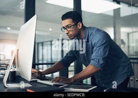 Coding, office and man on computer for programming, system upgrade and software design. Network, IT programmer and worker with pc for web development Stock Photo