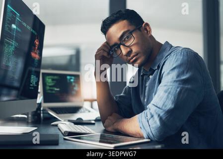 Man, portrait and software engineer with computer in office for coding, programming or algorithm. Male person, coder or developer with glasses or Stock Photo