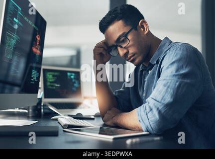 Frustrated, man and cyber attack with computer for virus, theft or cybersecurity breach in office. Male person, upset or programmer with tablet for Stock Photo