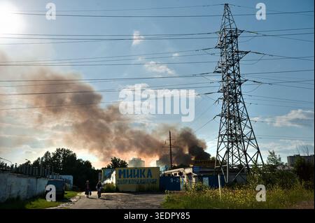 Editorial use. Power lines against the background of blue sky and black smoke on June 3, 2016 in Kiev Stock Photo