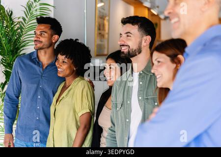 Diverse business team smiling together collaborating in office Stock Photo