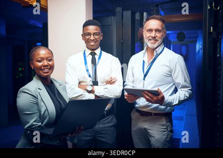 Tech, portrait and engineer team in server room for about us, programming and security service. People, tablet and laptop in datacenter for Stock Photo