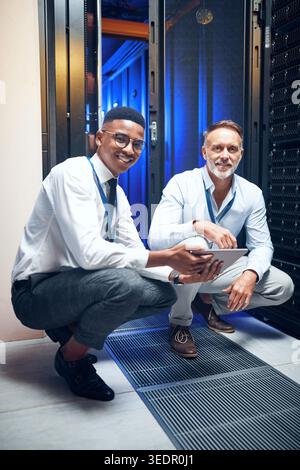 Portrait, people and programming with tablet in server room for research, coding and cybersecurity. Smile, men and teamwork with digital for software Stock Photo