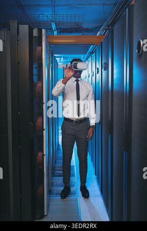 Man, inspection and vr glasses for programming in server room with cybersecurity, system test or iot hardware. Programmer, tech and app for augmented Stock Photo