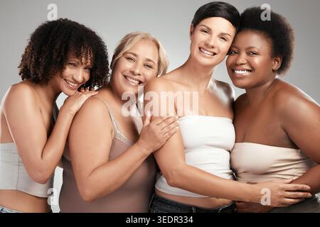 Diversity, portrait and women with hug in studio for skincare or dermatology on a white background. Multiracial, female people or group of friends Stock Photo