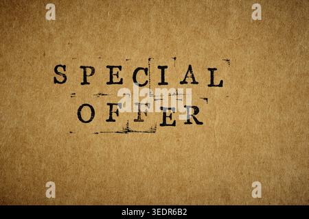 SPECIAL OFFER text stamped on vintage brown paper with grainy texture. Minimalist vertical design Stock Photo