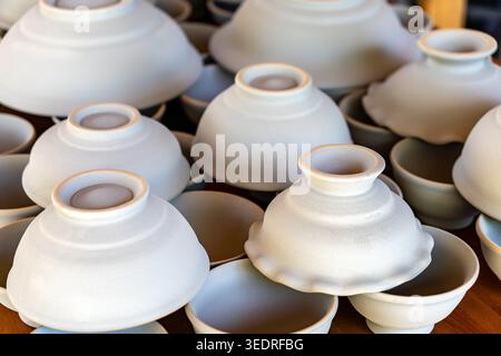 view of clay handicrafts in various shapes such as vases, glasses and bowls. Crafts from clay. Creativity. Stock Photo
