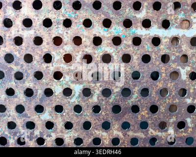 Rusty perforated plate as background or texture Stock Photo