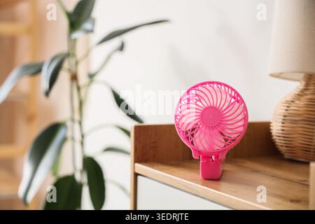 Small electric fan on table Stock Photo