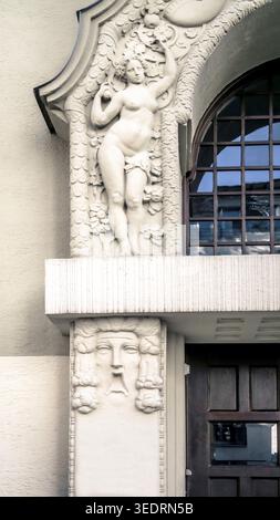 Artfully decorated entrance door with sculptural relief in Art Nouveau style in Bogenhausen in Munich, built around 1910. Stock Photo