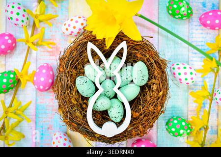 Easter bunny in an Easter nest with Easter eggs Stock Photo