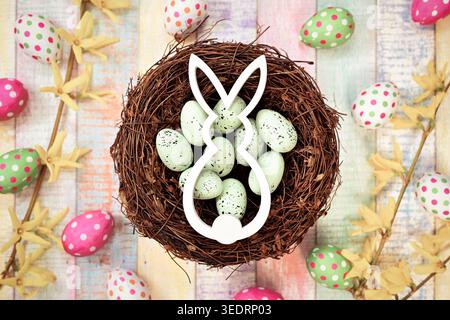 Easter bunny in an Easter nest with Easter eggs Stock Photo