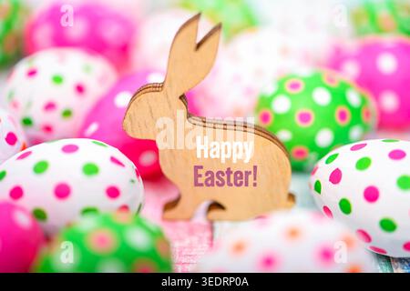 Easter bunny with colorful Easter eggs and Easter greeting happy Easter, photomontage Stock Photo