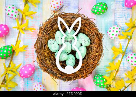 Easter bunny in an Easter nest with Easter eggs Stock Photo