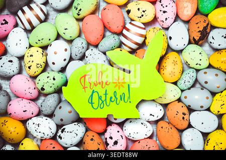Easter bunny figure with Easter eggs and Easter greeting, photomontage Stock Photo
