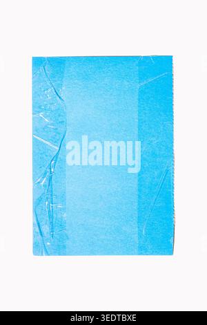 Blue textured paper background showing subtle creases from transparent tape and slight crumpling on the top edge, white background Stock Photo