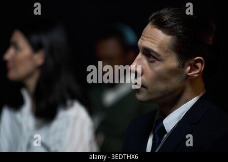 Adult Businessman Listening during Corporate Meeting or Seminar Stock Photo