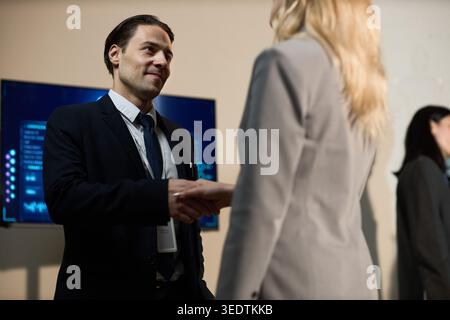 Businessman Shaking Hands during Corporate Networking Event Stock Photo
