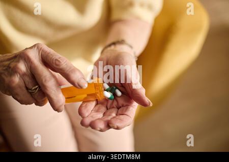 Senior Woman Pouring Prescription Pills for Daily Medication Stock Photo