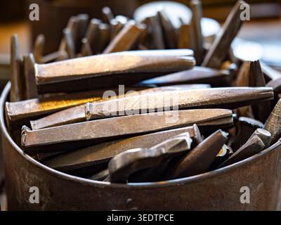 Historical Blacksmithing Tools and Steel Punches in Rusty Metal Container, Ott-Pausersche Fabrik Museum, Schwäbisch Gmünd, Germany Stock Photo