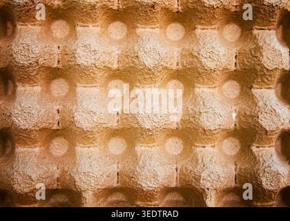 Detailed texture of an empty cardboard egg carton made from eco-friendly molded paper pulp. Abstract geometric background with copy space for design. Stock Photo