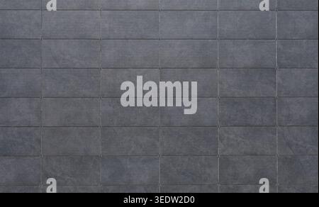 Dark gray sintered stone tiles coating of a ventilated facade. Background and texture. Stock Photo