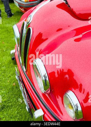 A close-up shot of the front of a classic red 953 Bristol 401 vintage car showing the distinctive chrome radiator grille and round headlights Stock Photo