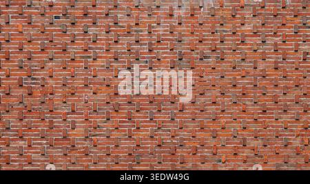 Brick wall with some bricks protruding outward from the main plane of the wall. Protruding brickwork. Full frame, background and texture. Stock Photo