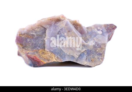 Raw blue chalcedony gemstone with traces of other minerals. White background. Stock Photo