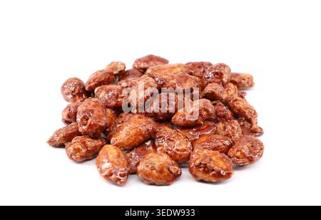 Heap of caramelized almonds on white background. Stock Photo