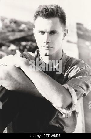 Black and White Portrait of Serious Young Man in Dramatic Natural Light Stock Photo