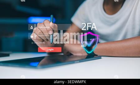 Person using stylus pen for secure login with 2FA two factor authentication and virtual shield icon. Cyber security, data protection and digital ident Stock Photo