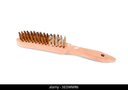 a wooden wire brush with brass bristles on a white background, hand tool used for cleaning rust metal surfaces and removing paint in repair and mainte Stock Photo