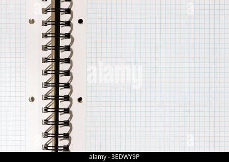 Blank white squared notebook page with metallic spiral binding. template mockup Stock Photo