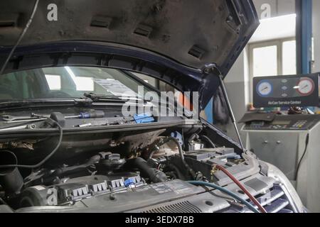Car Air Conditioning Recharge Service with Freon Machine in Auto Repair Shop - Car AC Maintenance and Refrigerant Recharge Equipment in Garage Stock Photo