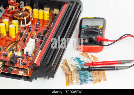Multimeter with test probes and a circuit board and resistors Stock Photo