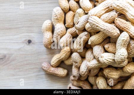 Close-up with a pile of peanuts in their shells Stock Photo
