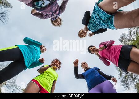 Group of diverse women training outdoors, working on their fitness and teamwork Stock Photo