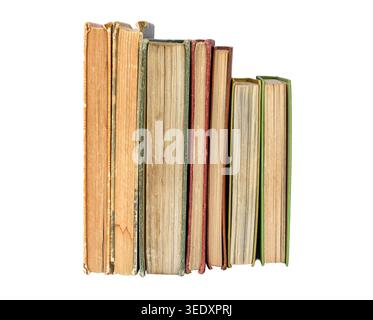 Collection of worn vintage books standing upright with aged pages and distressed covers isolated on white background. Ideal for education, literature, Stock Photo
