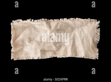 Rectangular linen fabric swatch with slight wrinkles and frayed edges isolated on black background. Natural textile sample ideal for material mockup, Stock Photo
