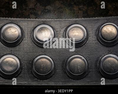 Close up top view of a blister pack of Voniko A76 LR44 alkaline button cell batteries in a security package for small electronics and household items Stock Photo