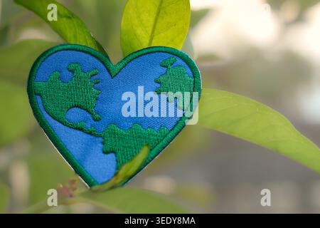 Environment Heart Heart world map in a natural woodland setting. Symbol of environmental ...