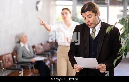 male inexperienced new employee is upset because of boss s scolding Stock Photo