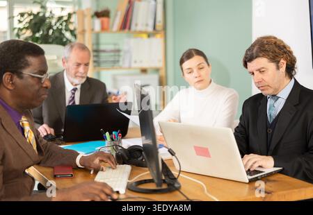 Employees work together in the office, they discuss everyday issues Stock Photo