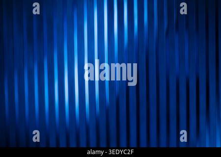 Abstract blue corrugated glass texture with vertical lines and bright light reflections Stock Photo